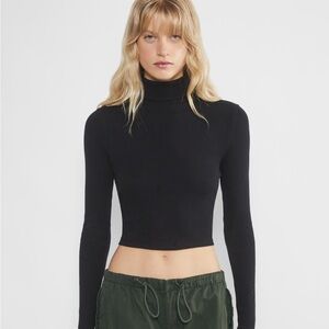 Aritzia black turtleneck, size small, stretchy HomeStretch™ fabric, tight fit